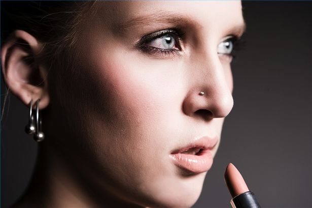 Professional Woman With Ear & Nostril Piercings