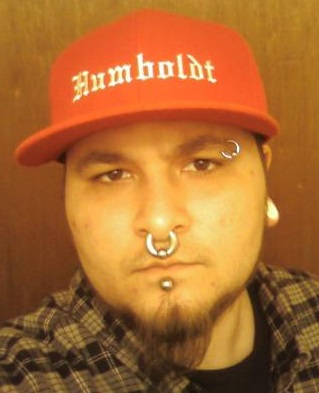 Man with stretched labret and septum piercings