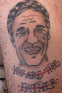 Bad Portrait Tattoo With the Words You Are the Father Struck Out Below the Man's Face 