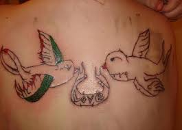 Bad Tattoo of Swallows Holding a Banner Reading Love 
