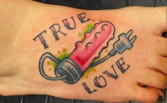 Bad Tattoo of a Vibrator With the Words True Love Around It 