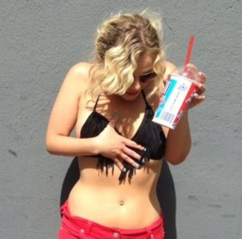 Bikini-Clad Woman Looking at Her Belly Button Ring 