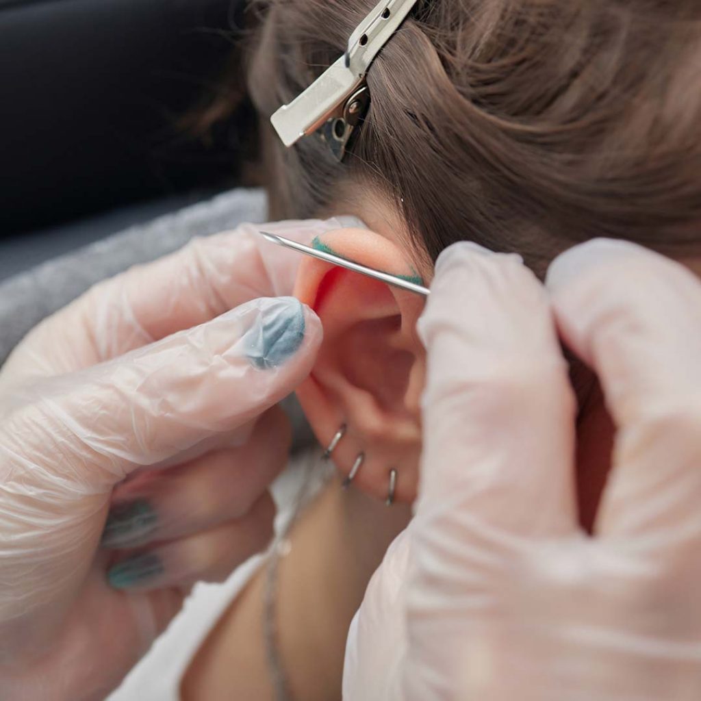 Piercing client getting marked for an industrial piercing