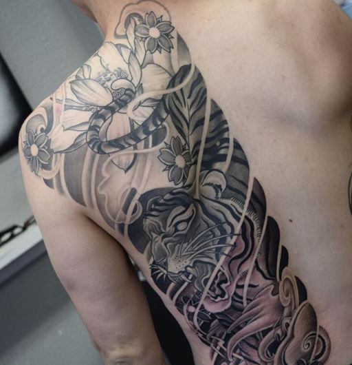 Japanese irezumi style in black and grey featuring a tiger and florals as a half-back piece