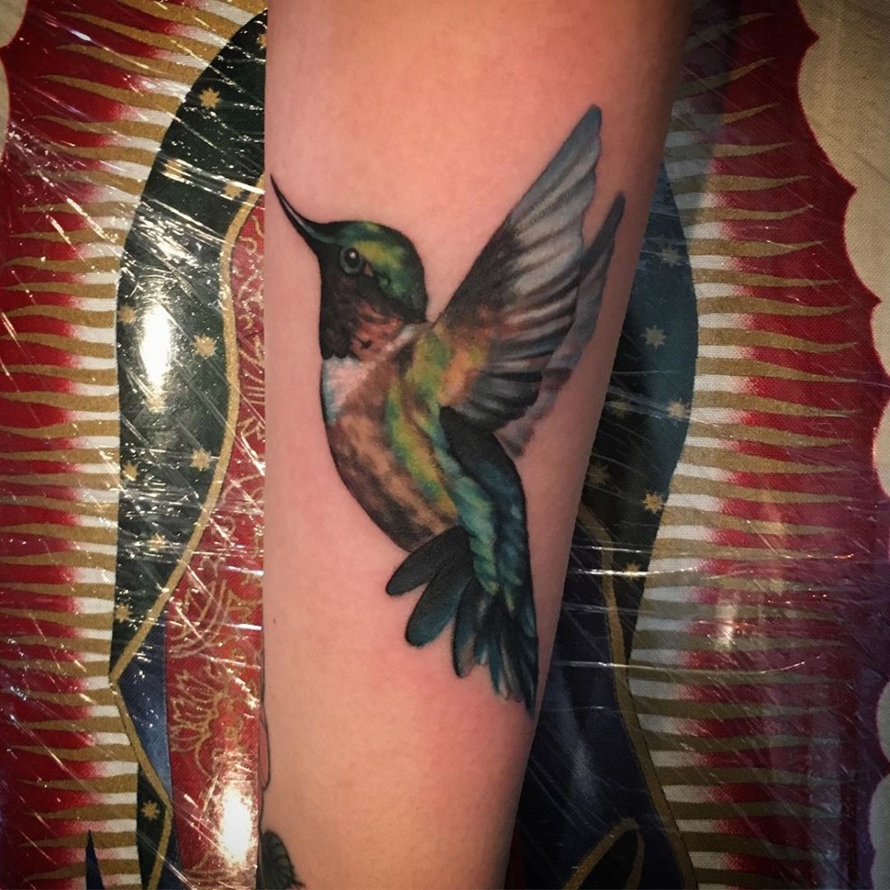 Colorful hummingbird tattoo by tattoo artist Mandy Fabrizi
