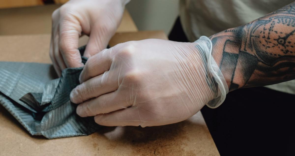 Tattoo artist wearing vinyl gloves for shop cleaning procedures Tattoo artist wearing vinyl gloves for shop cleaning procedures