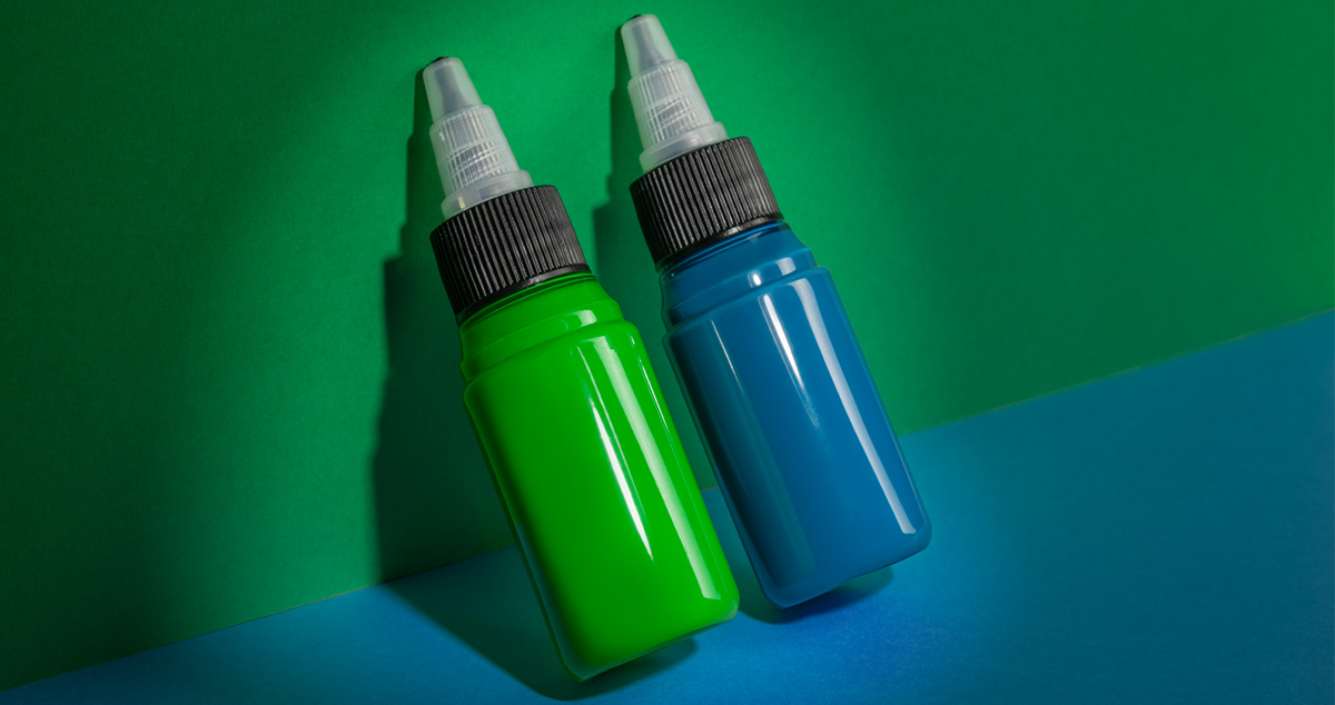 Two bottles of blue and green tattoo inks containing blue 15:3 and green 7 pigments