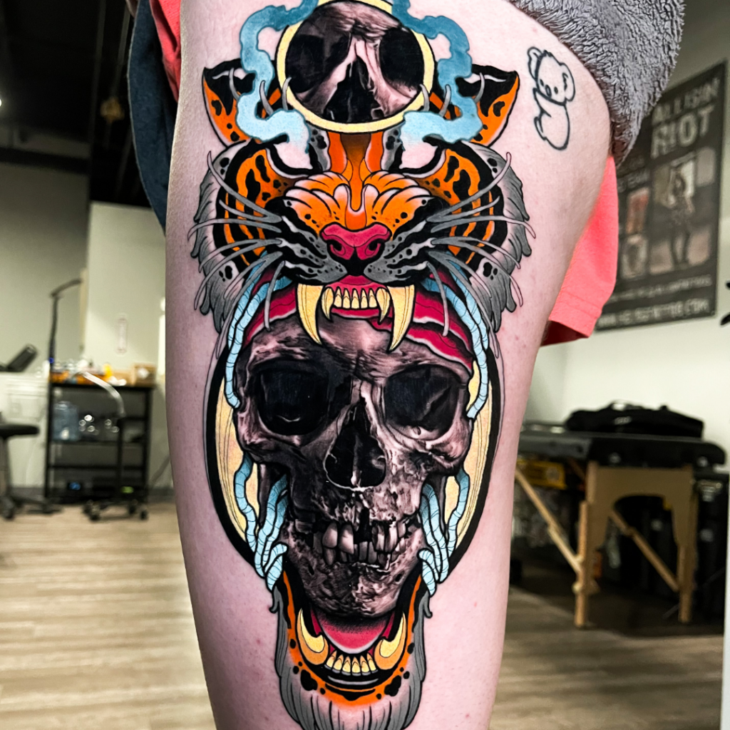 Tattoo of skull with tiger head by Harlan Kantner and Kasey Gonzalez