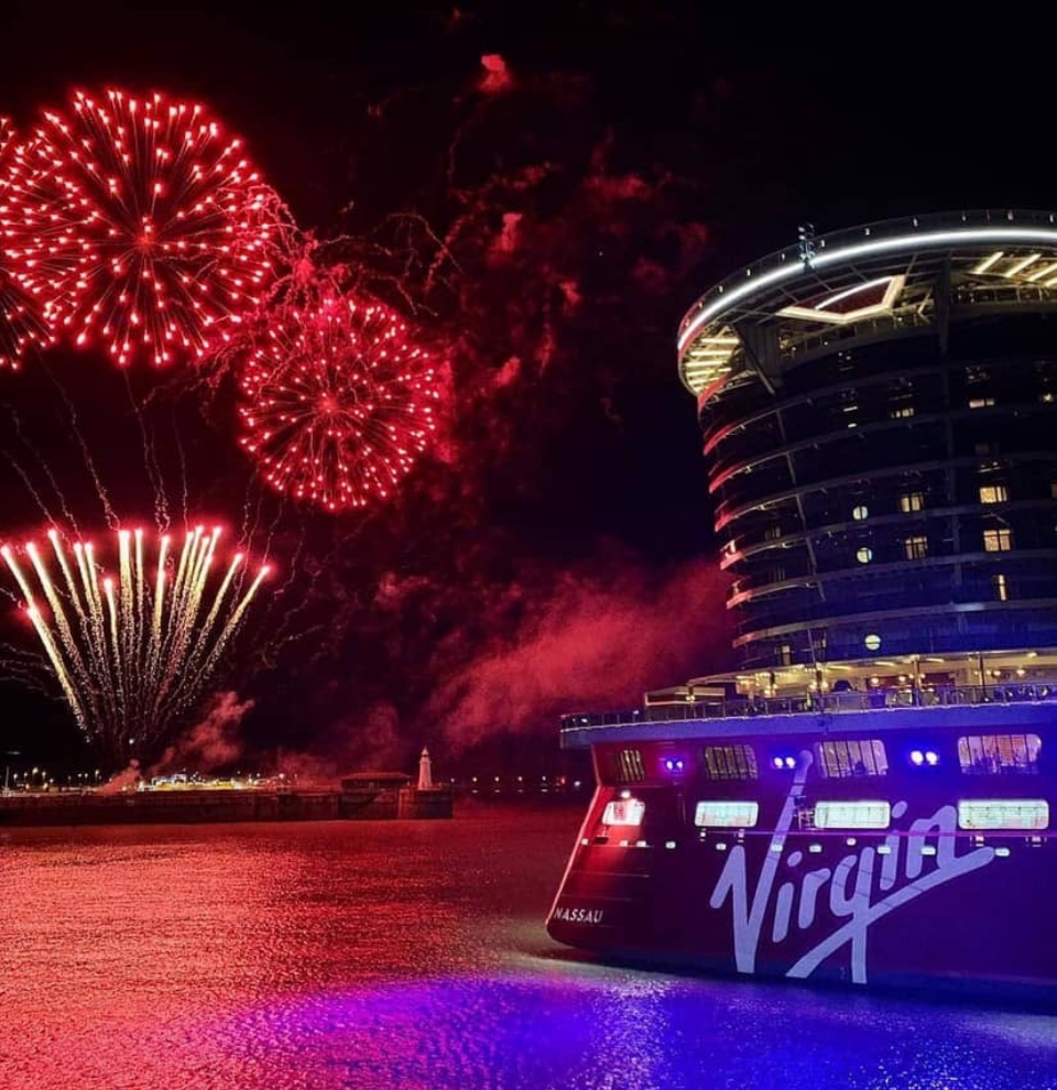 Virgin Voyages Scarlet Lady ship watching fireworks on the water