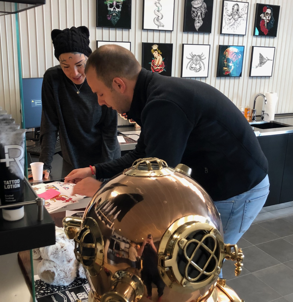 Tattoo artists planning in the Squid Ink studio