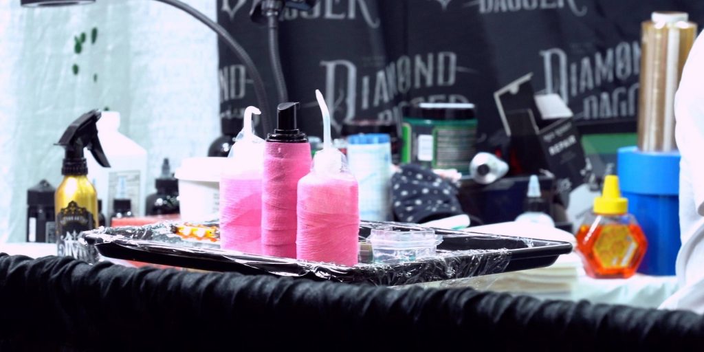 Standard tattoo convention supplies including washer andd spray bottles on a medical tray at a tattoo convention