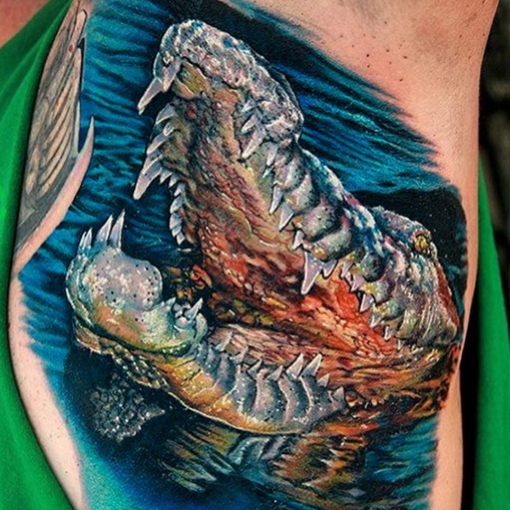 Tattoo client with realistic crocodile tattoo in armpit