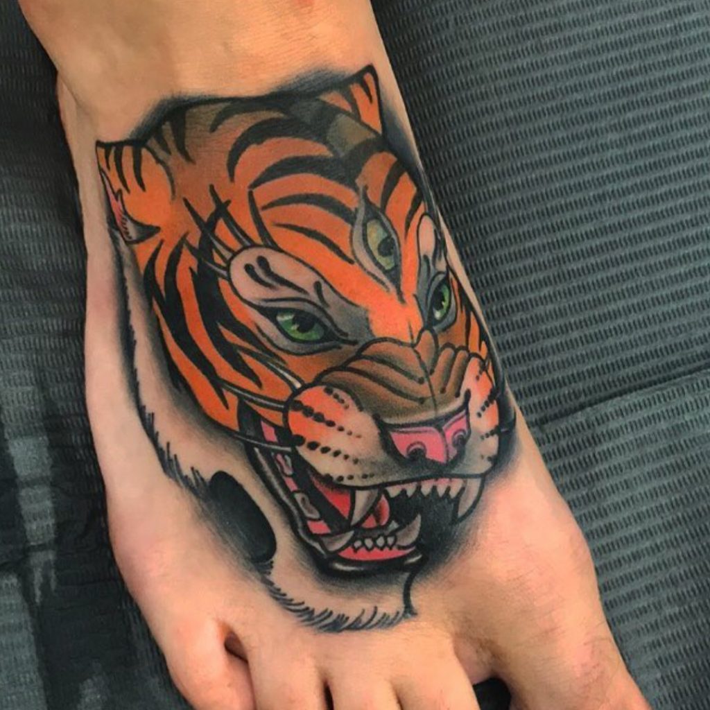 Tattoo client with neotraditional tattoo on foot