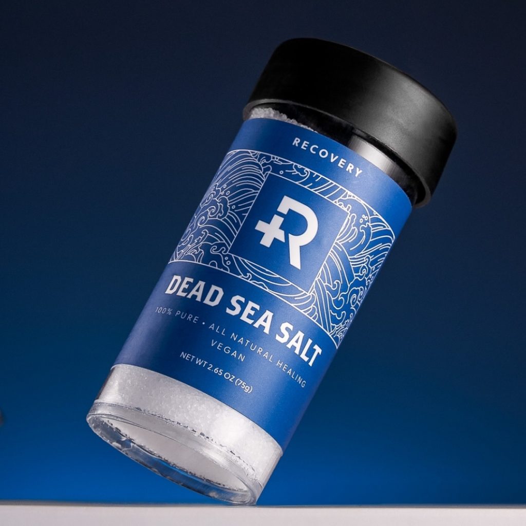 Bottle fo Recovery Dead Sea Salt with a blue backdrop