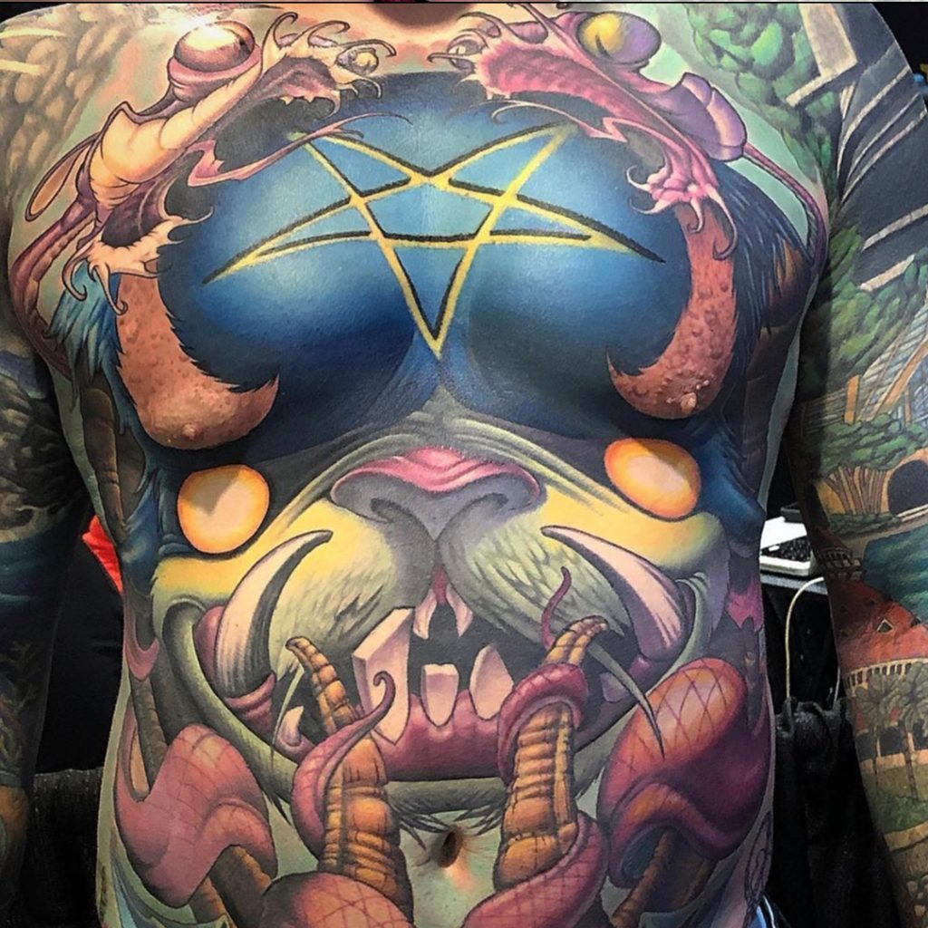 Tattoo client with stomach tattoo