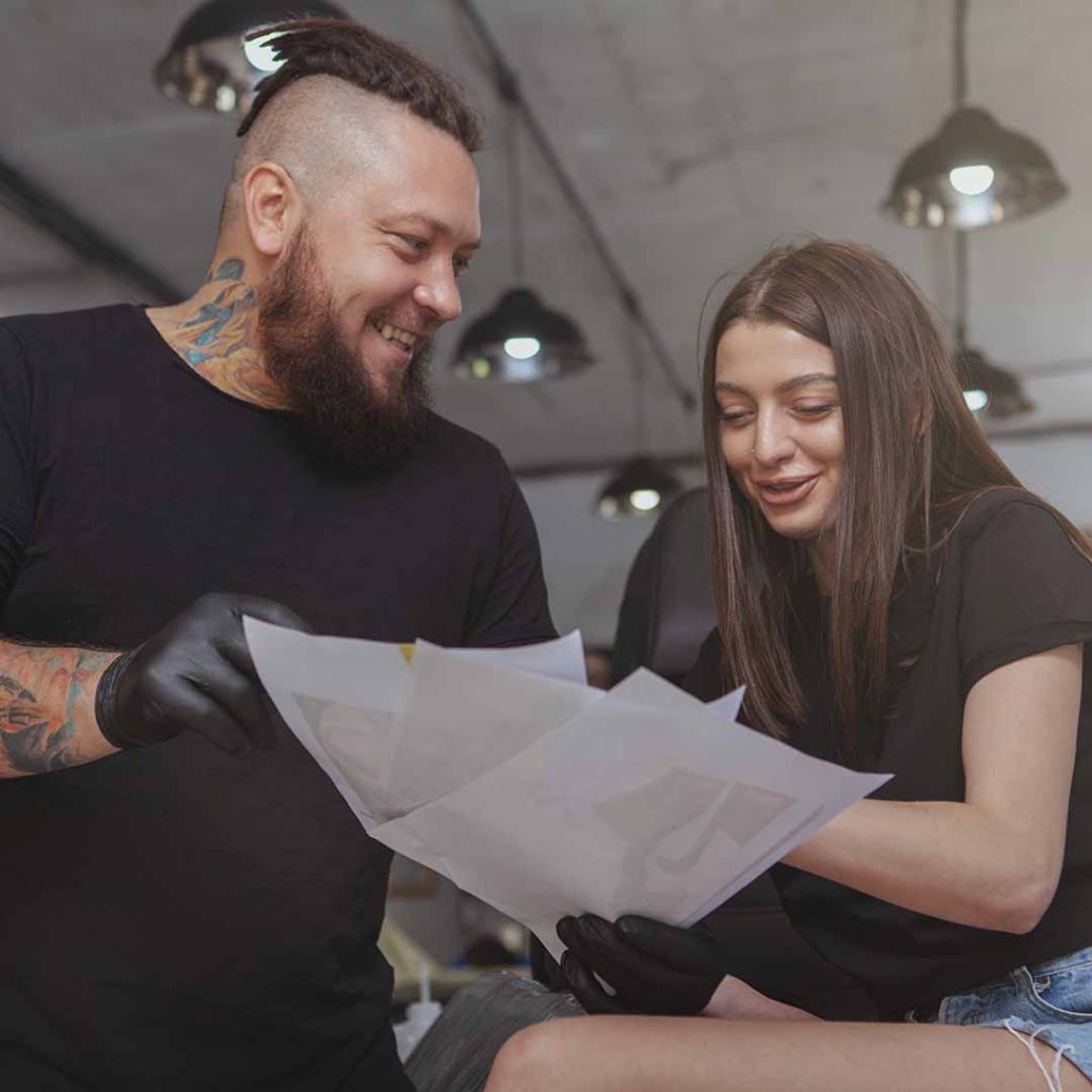 Tattoo artist going over a contract with a client