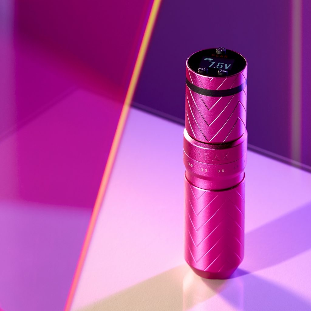 Peak tattoo machine in pink on a pink backdrop