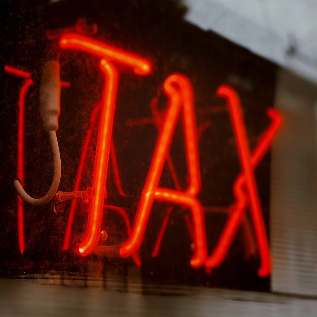 Neon sign that says Tax