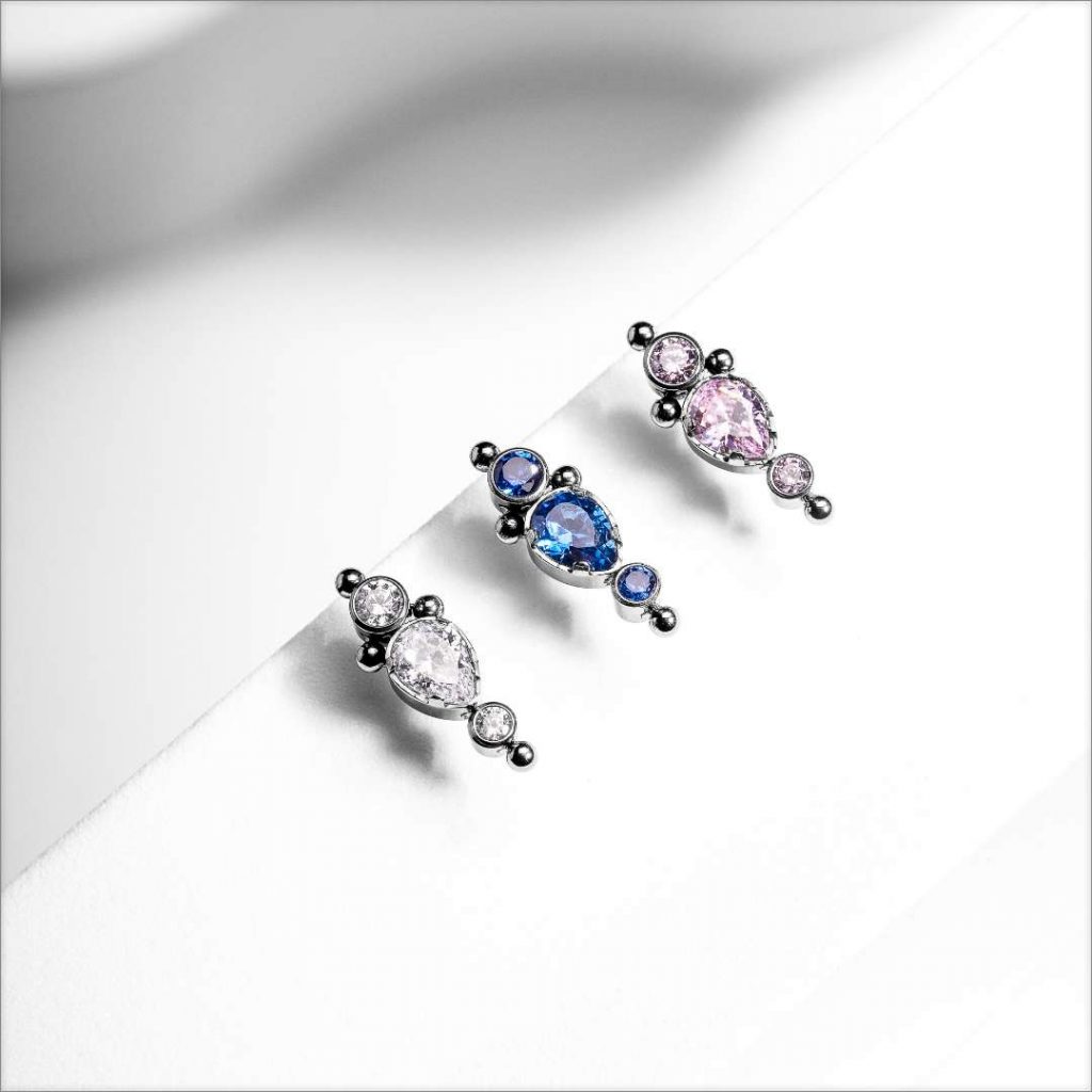 Dermal tops made of titanium with three different jewel colors