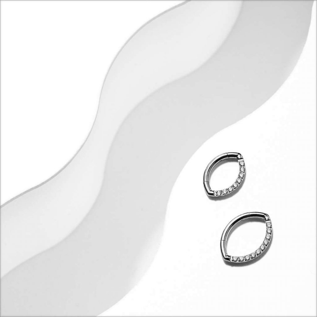 Oval clicker rings made of titanium on a white background