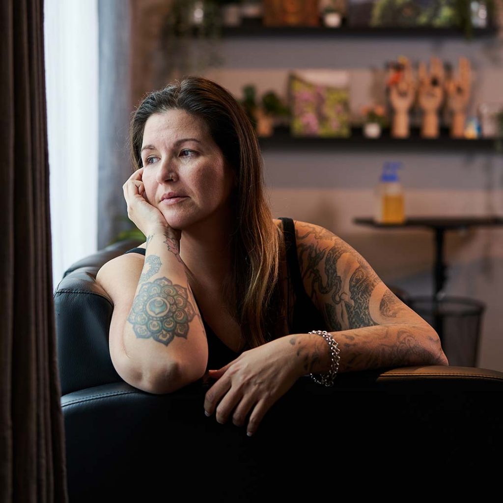 Tattoo artist looking depressed on a couch