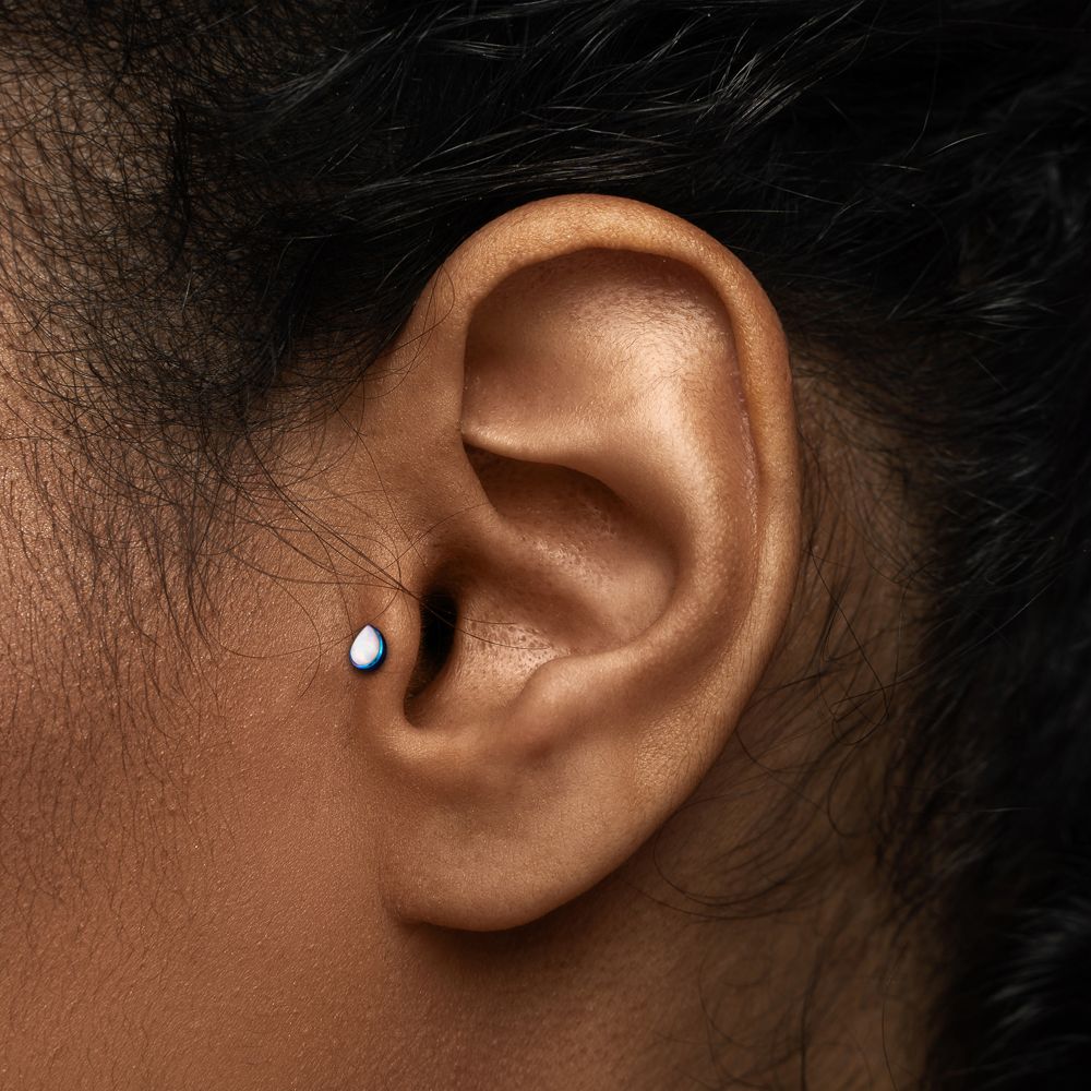 Client wearing threadless jewelry in cartilage
