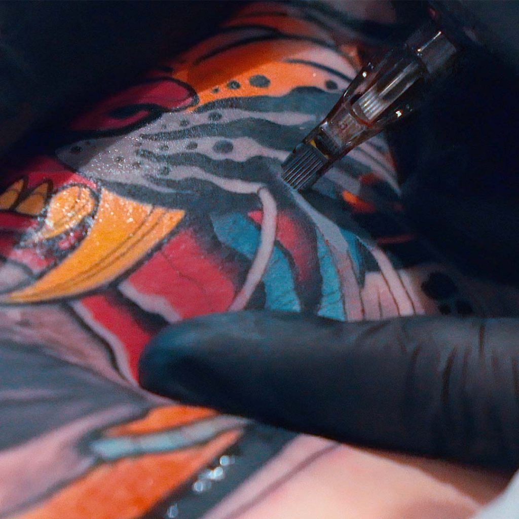 Close-up o f tattoo needle cartridge on neotraditional tattoo 